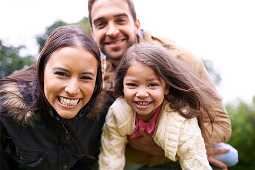 Happy family of three taking a selfie in Gooseberry Park in Moorhead, MN